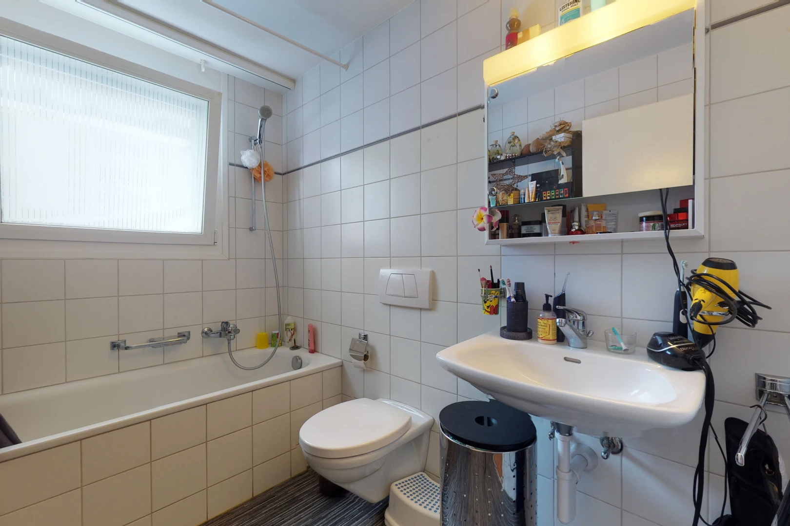 full bathroom featuring natural light, sink, toilet, shower / bath combination, and mirror