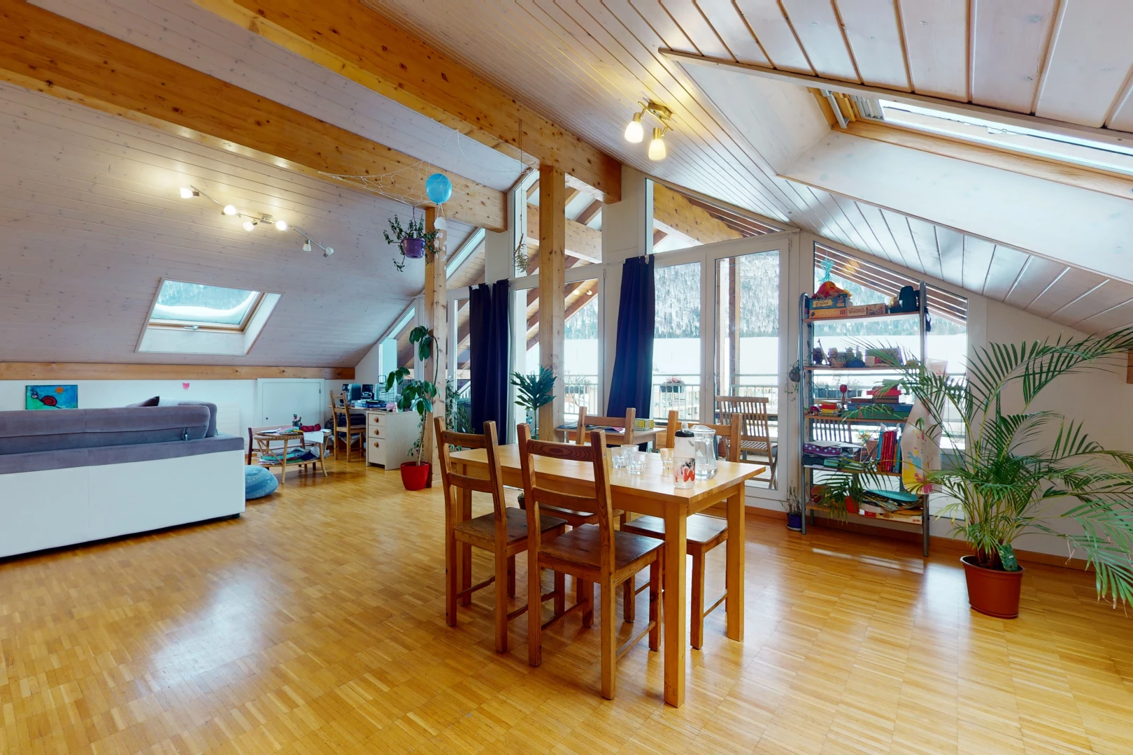 dining room featuring natural light, vaulted ceiling with skylight, and wood-type flooring