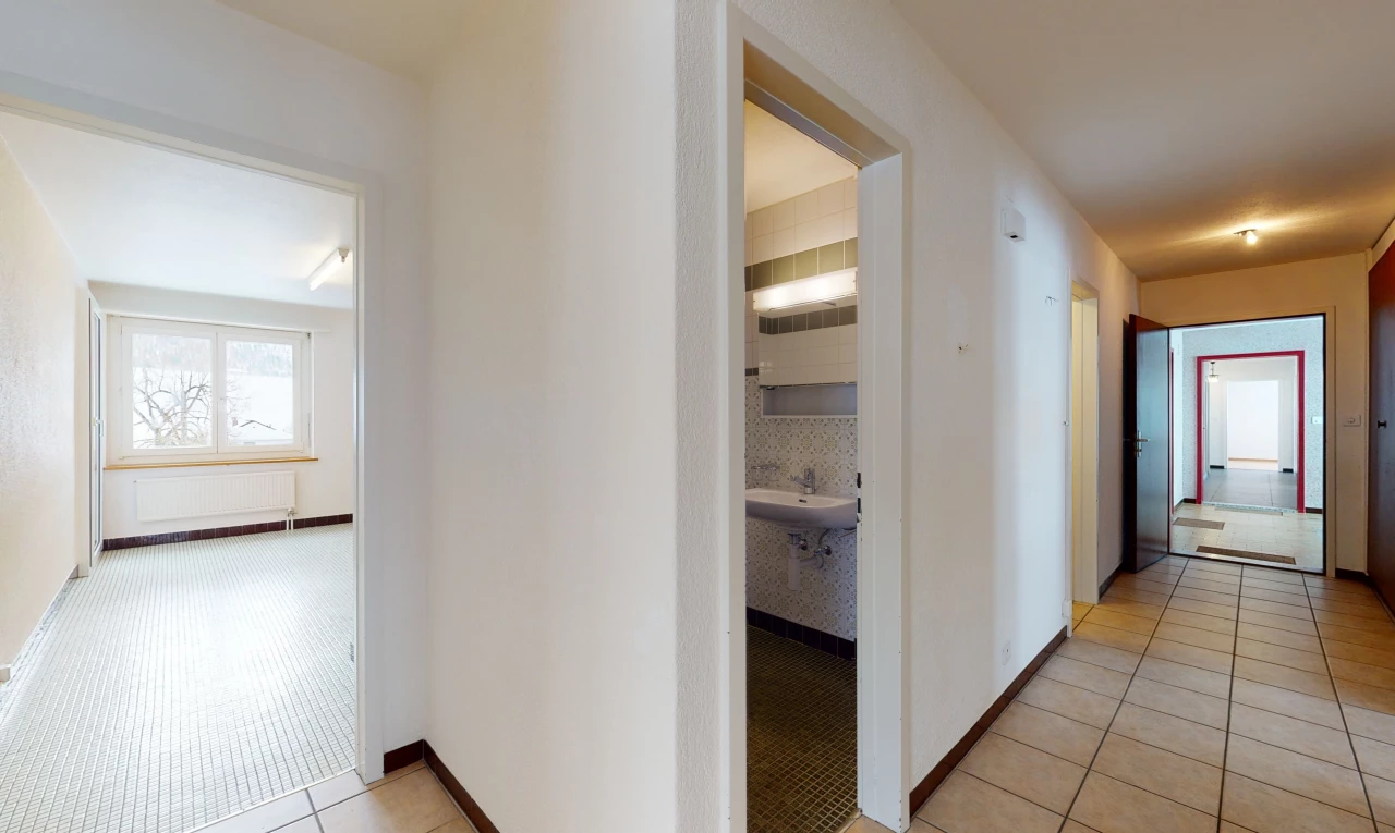 hallway featuring carpet and natural light