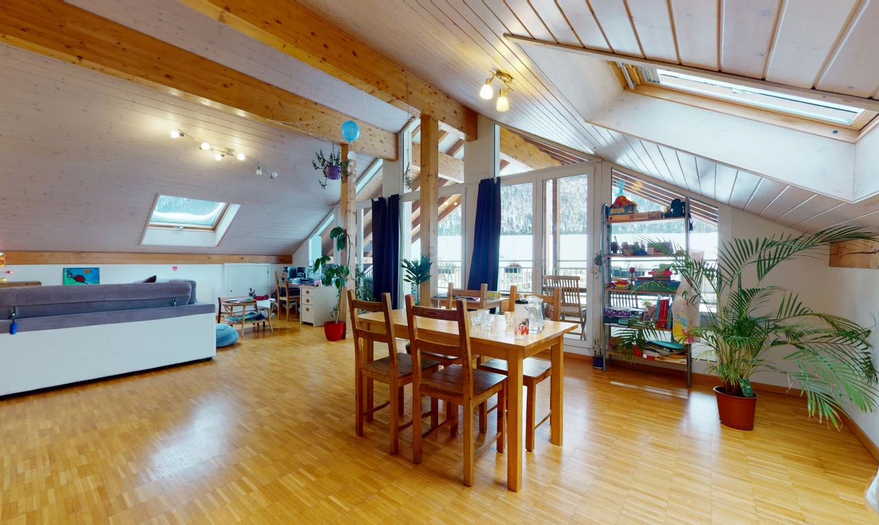 dining room featuring natural light, vaulted ceiling with skylight, and wood-type flooring