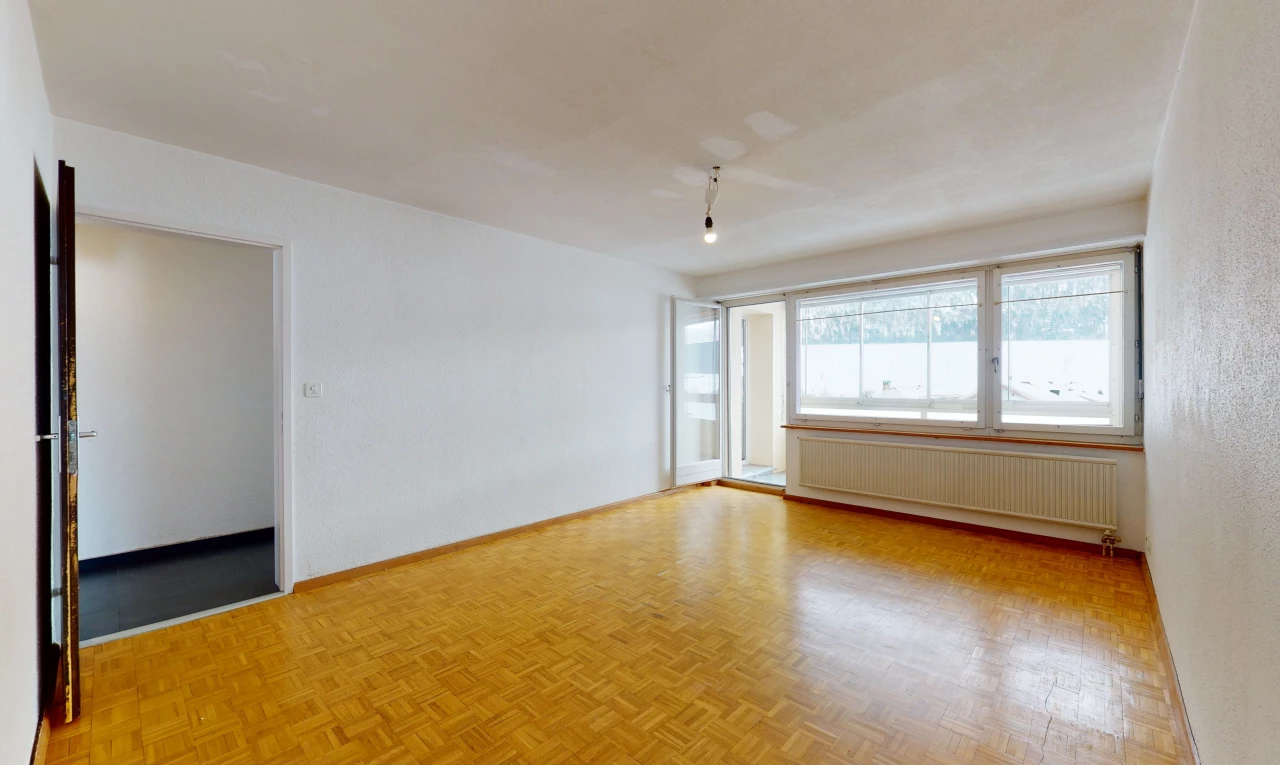 spare room featuring hardwood floors, natural light, and radiator