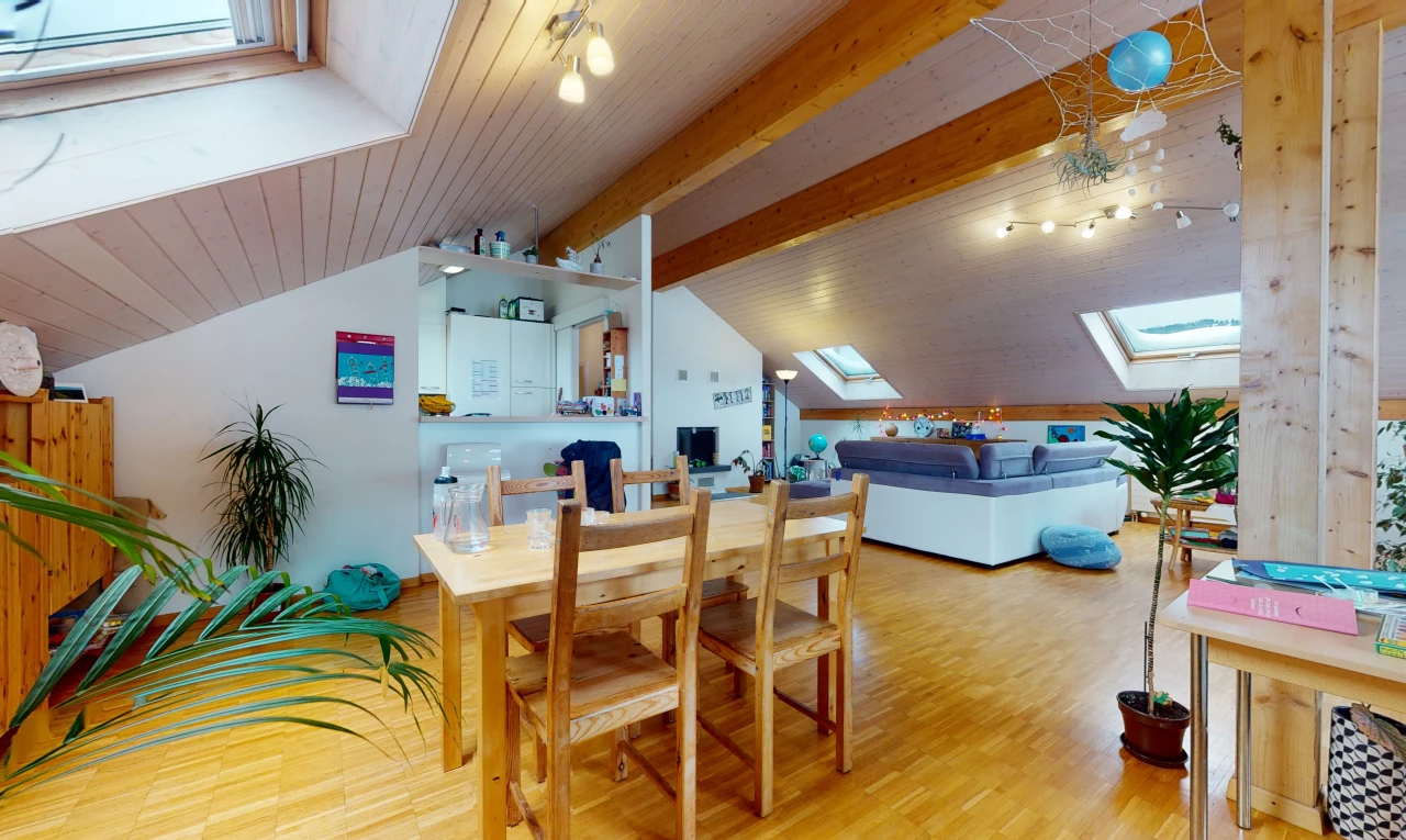 dining area with natural light, lofted ceiling with skylight, and hardwood floors