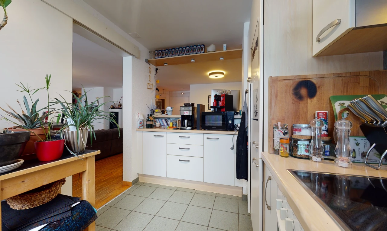 kitchen with electric cooktop, microwave, light tile floors, and white cabinetry