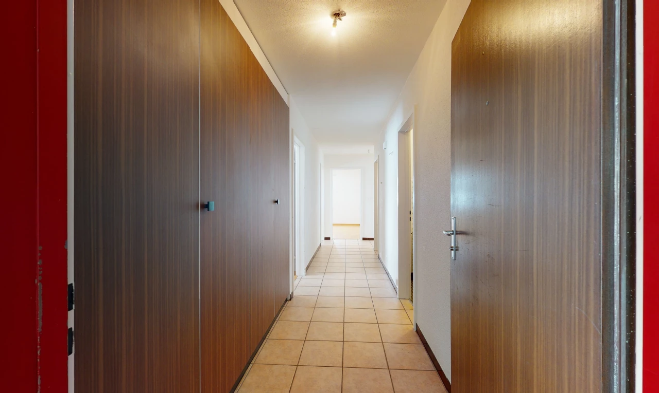 hallway with tile flooring