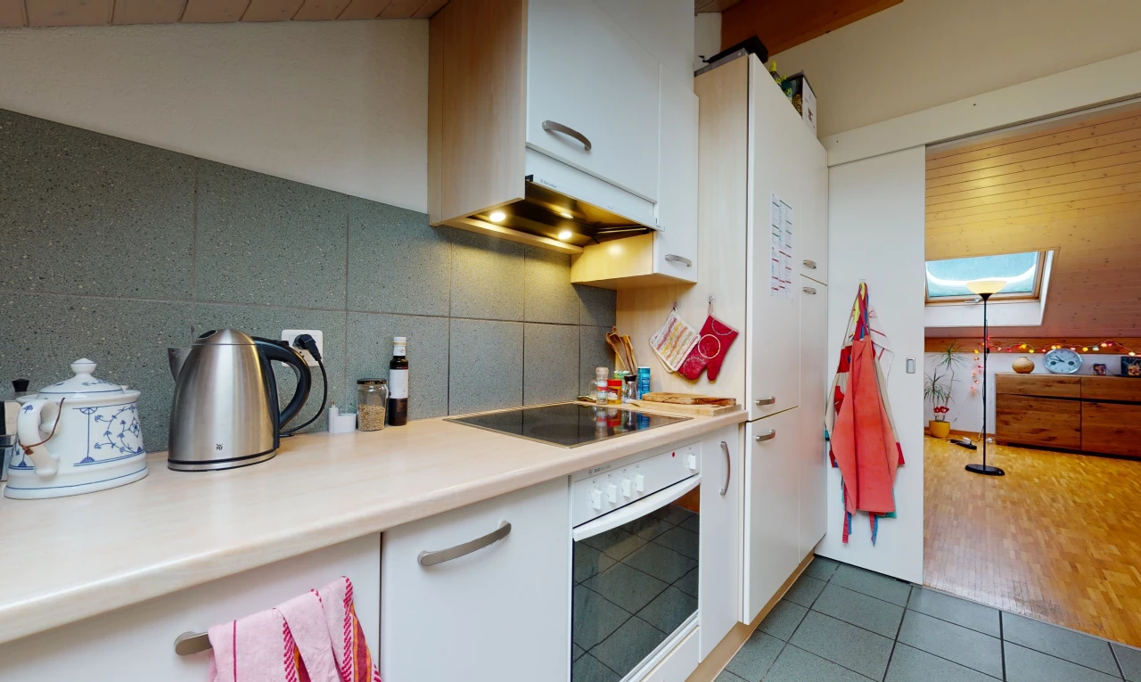 kitchen with oven, electric cooktop, light tile floors, and light countertops