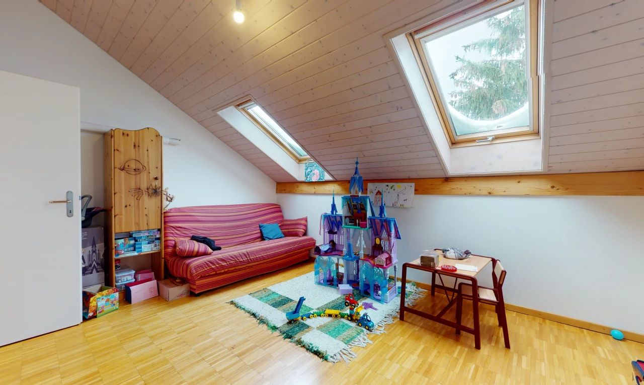 exercise room with lofted ceiling with skylight, hardwood flooring, and natural light