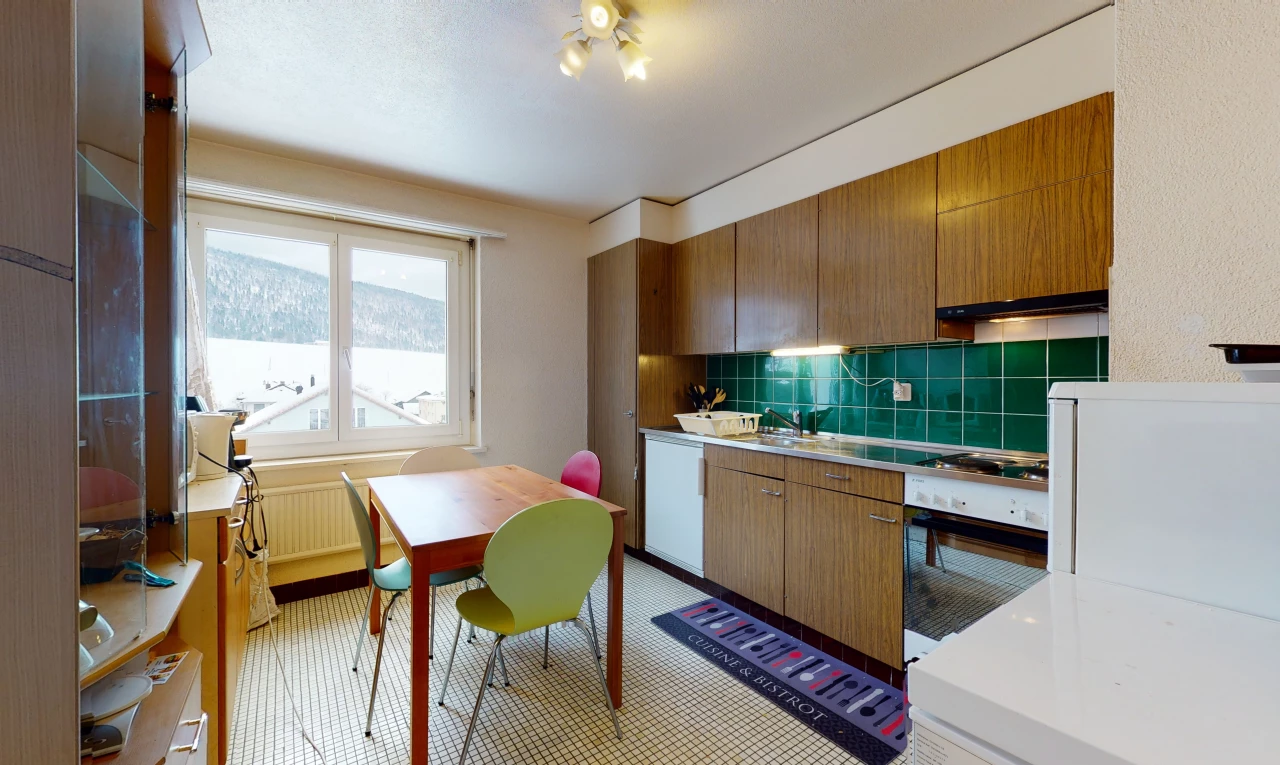 kitchen featuring natural light, oven, light flooring, and light countertops