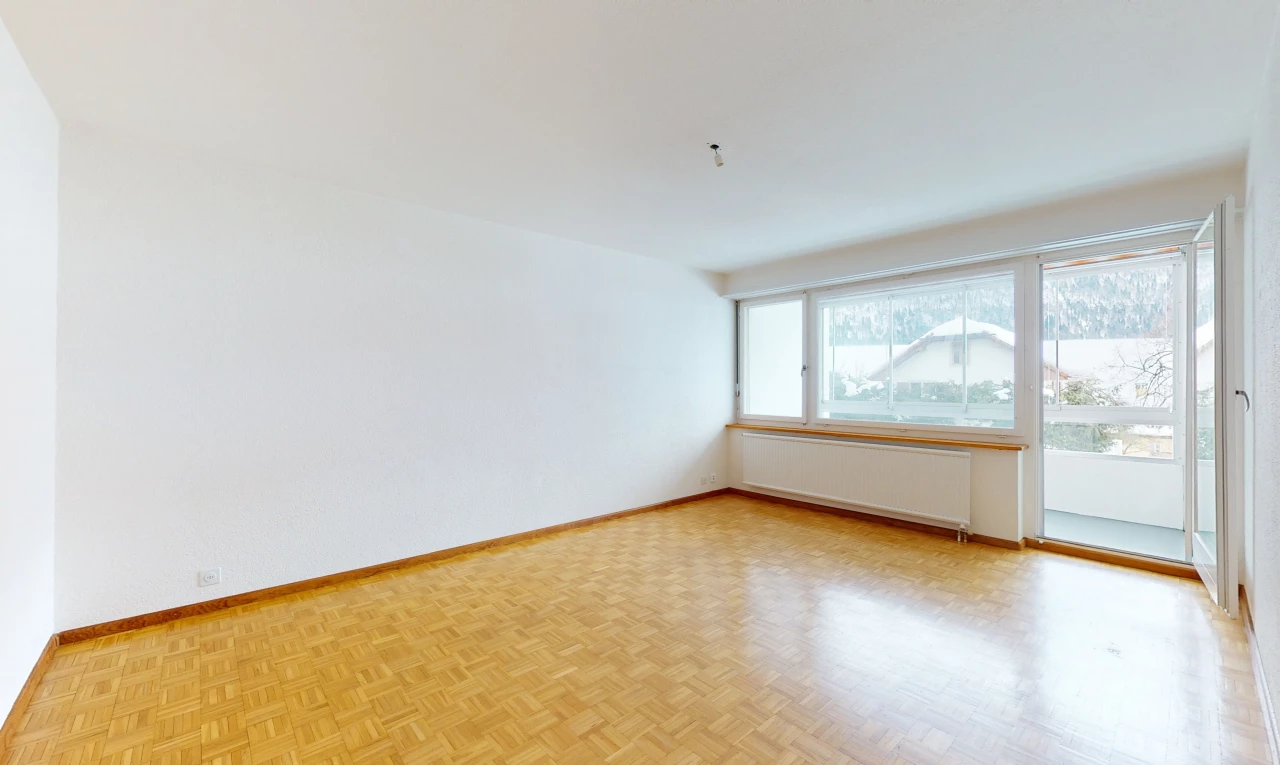 hardwood floored empty room featuring natural light