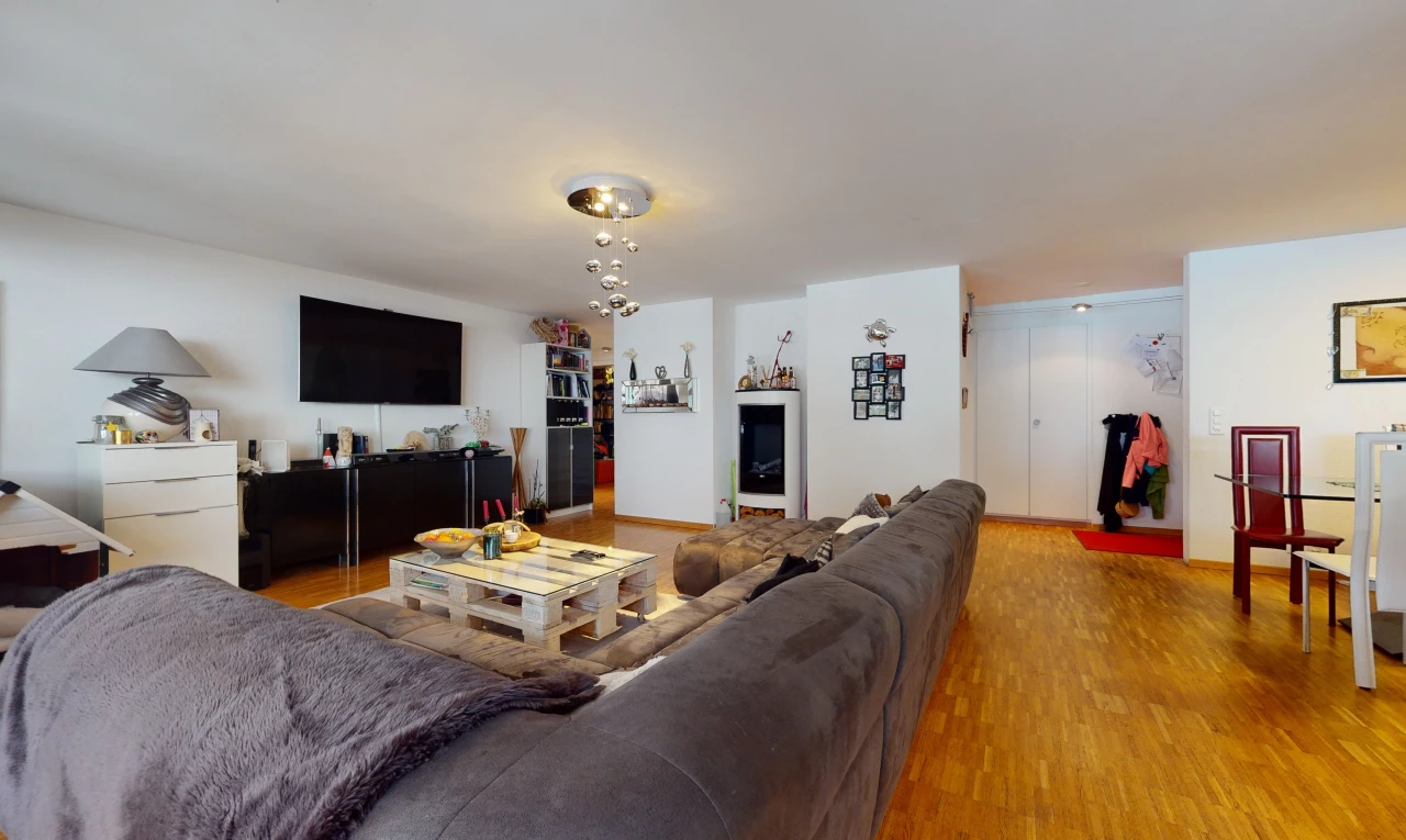 hardwood floored living room featuring TV