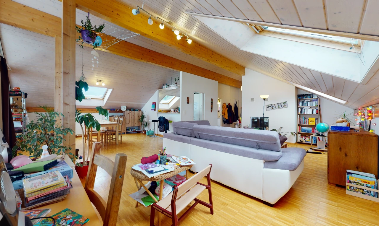 hardwood floored living room with beamed ceiling, natural light, skylight, and TV