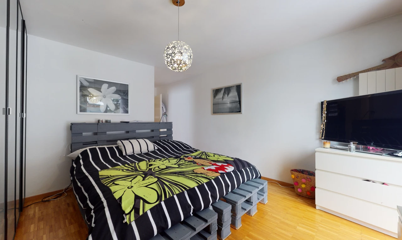 bedroom featuring hardwood flooring and TV