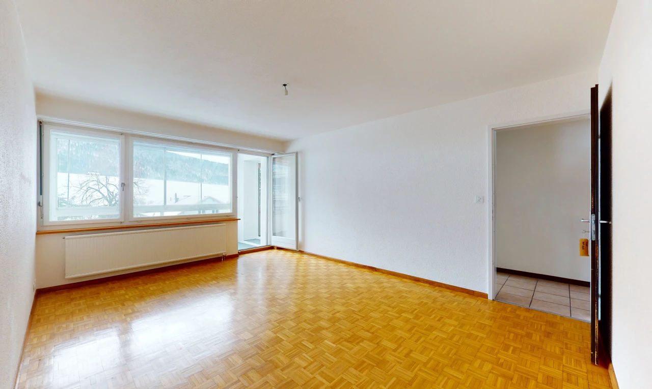 empty room with natural light, tile floors, and radiator