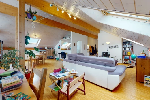 hardwood floored living room with beamed ceiling, natural light, skylight, and TV