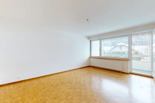hardwood floored empty room featuring natural light