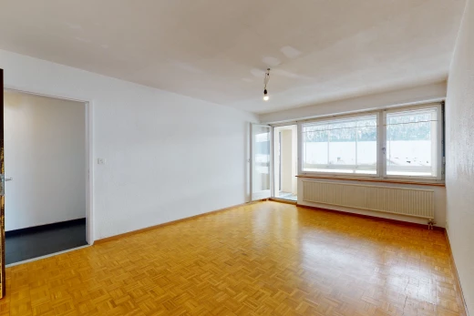 spare room featuring hardwood floors, natural light, and radiator