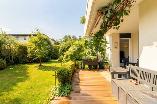 garden featuring a lawn, a deck, and a putting green