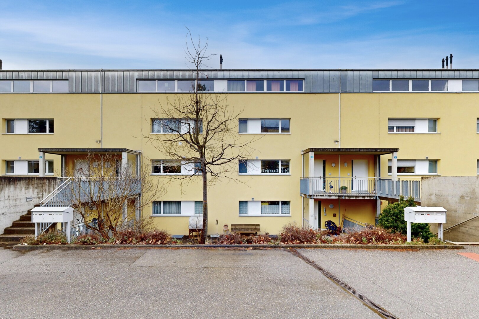 view of apartment building / complex featuring stairway