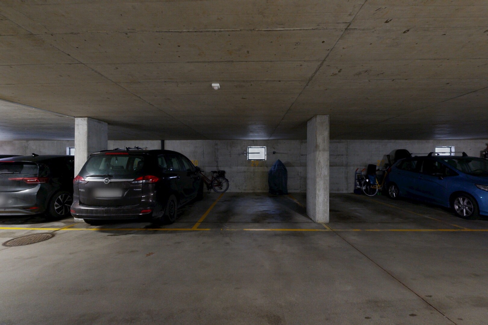 view of parking with a parking deck
