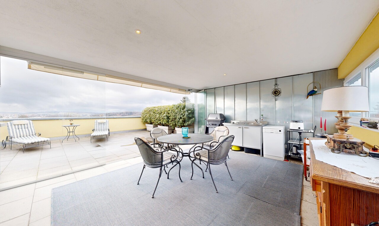 terrace with an outdoor kitchen / dining area and a patio