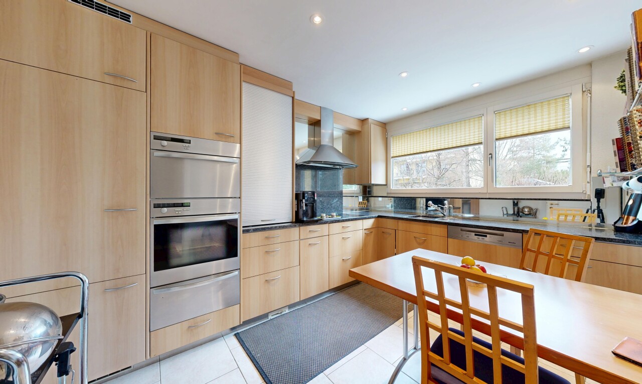 kitchen featuring light wood finish cabinetry, a warming drawer, modern cabinets, stainless steel appliances, and recessed lighting