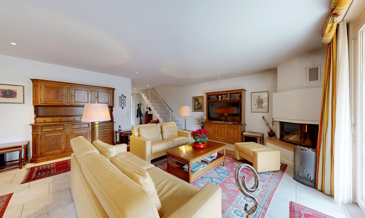 living area featuring light tile patterned flooring and stairs