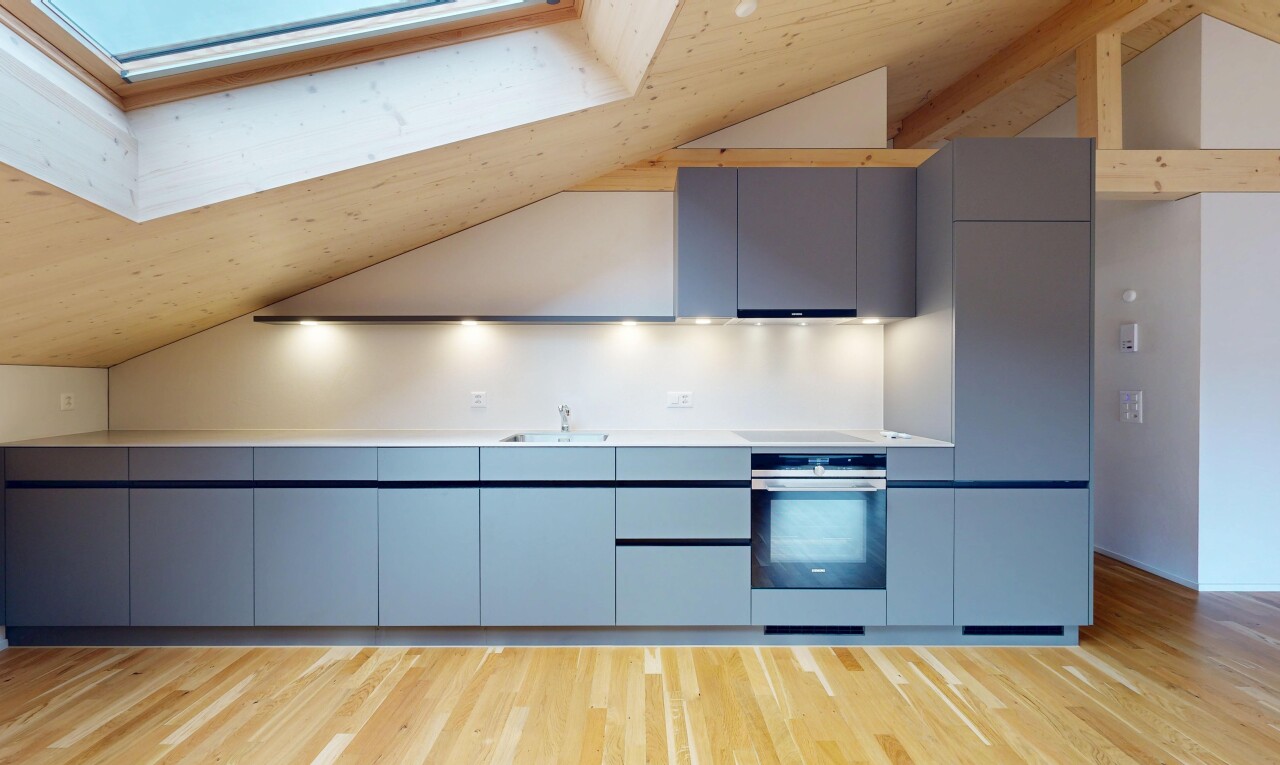 cuisine avec armoires à panneau plat, vaulted ceiling, plafond voûté, wood finish floor, et sol en finition bois