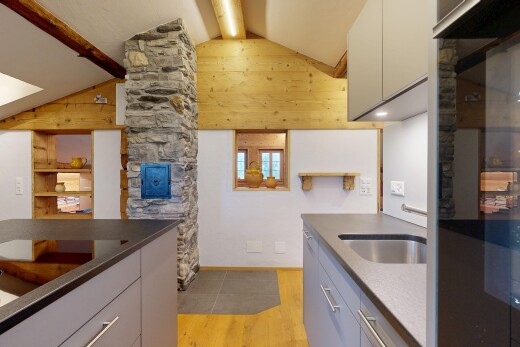 küche mit light floor, dark countertops, holzfußboden, wood finish floor, und inside property