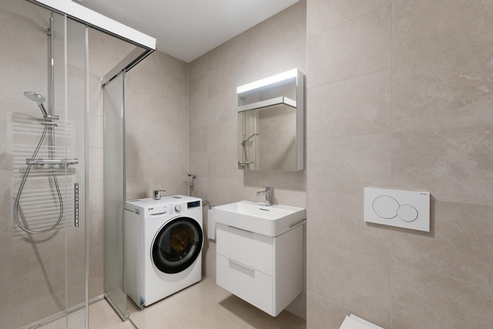 full bath with washer / dryer, vanity, a stall shower, and tile walls