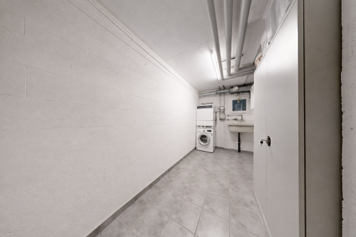 laundry room with a sink and stacked washer and dryer