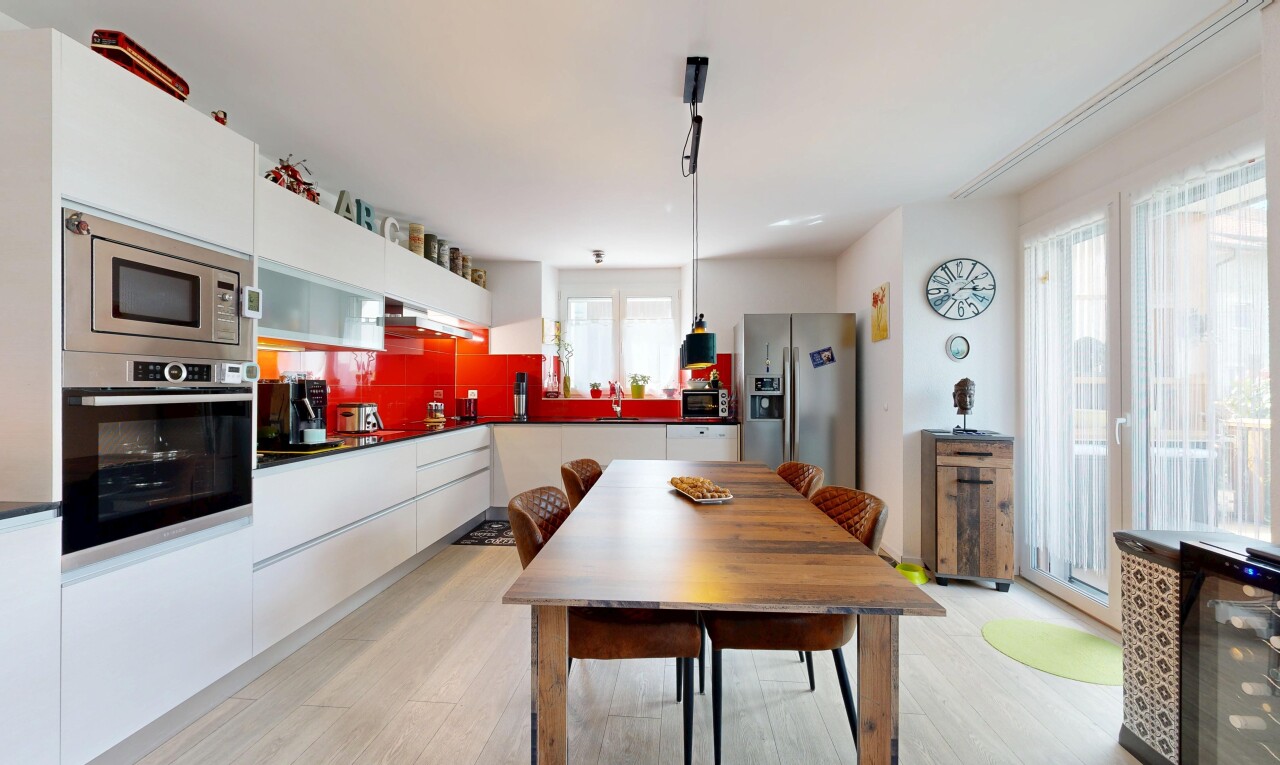 kitchen featuring appliances with stainless steel finishes, light wood-style floors, pendant lighting, dark countertops, and white cabinetry