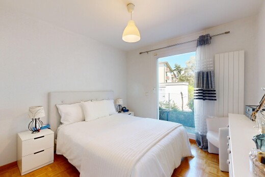 chambre avec éclairage suspendu, drywall, cloison sèche, wood finish floor, et sol en finition bois