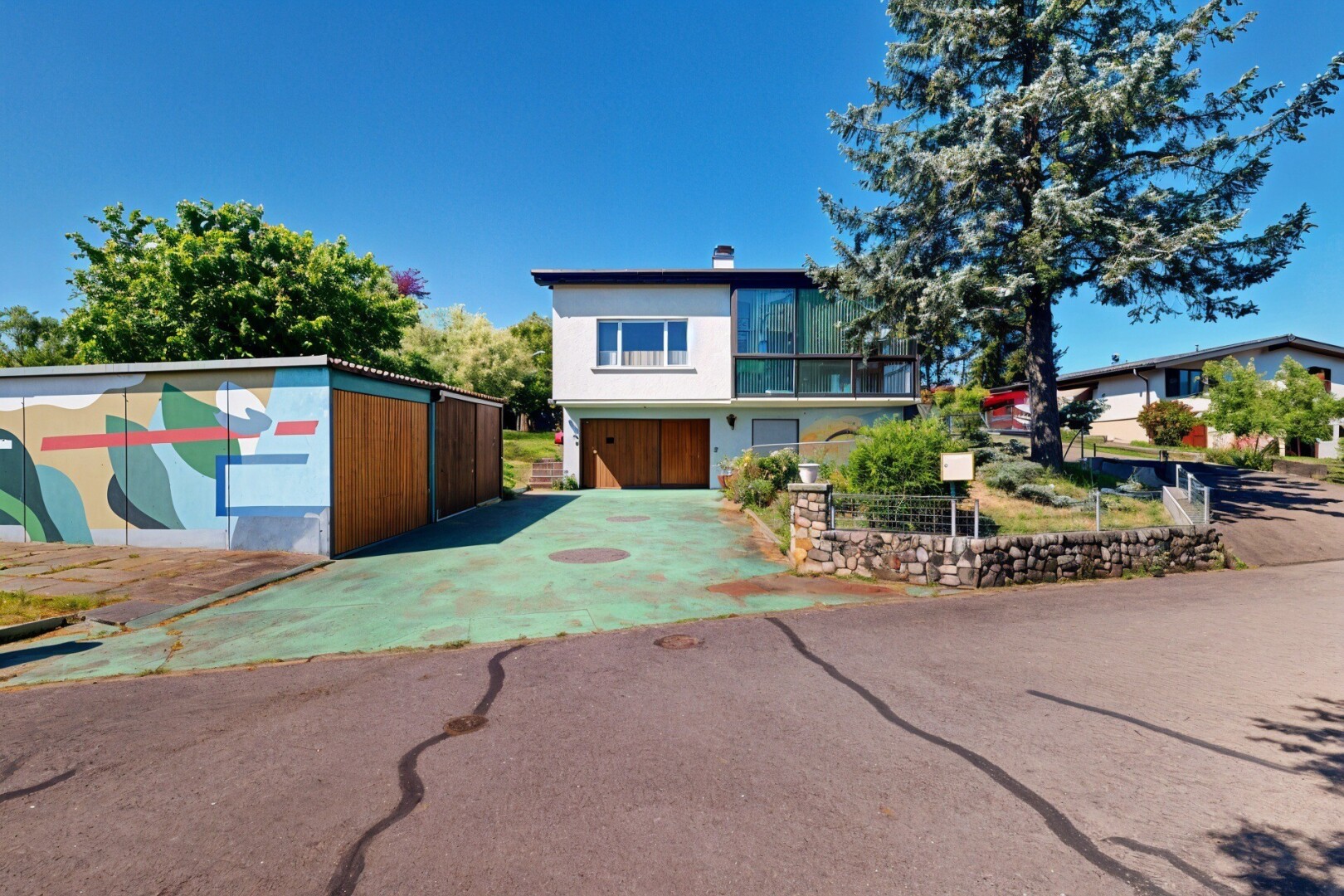 view of home featuring driveway and a chimney