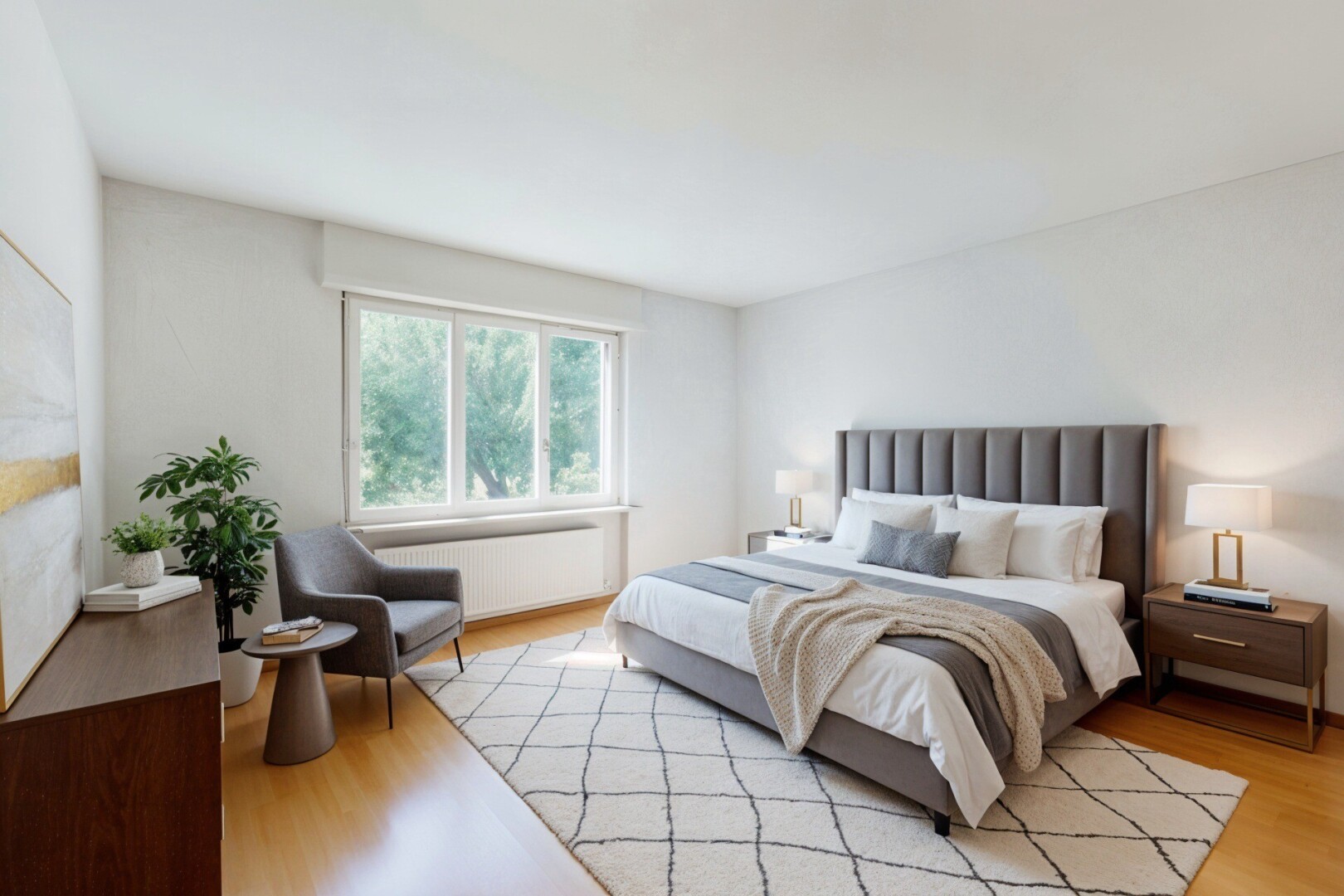 room with a chandelier, light wood-style flooring, radiator heating unit, and baseboards