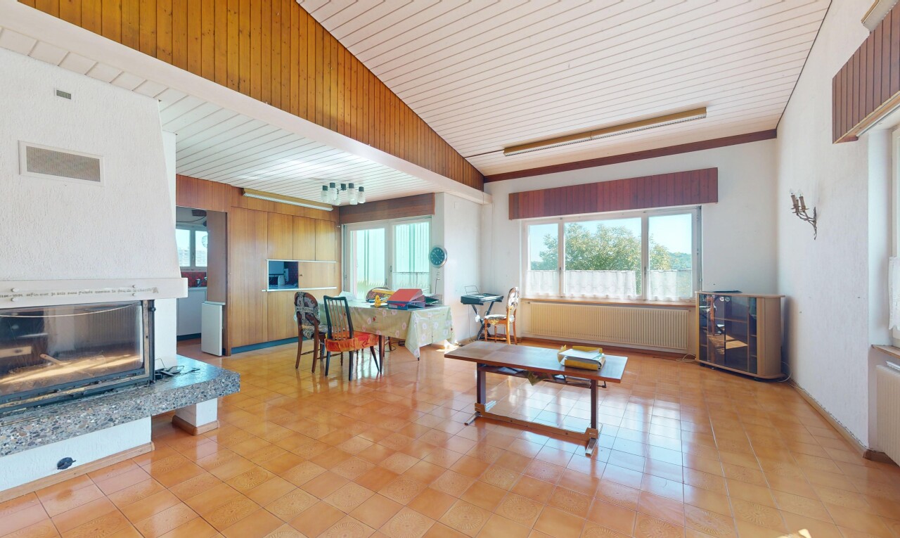 living area featuring radiator and a fireplace with raised hearth