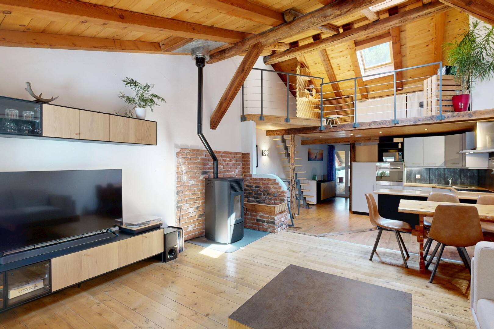 living area with a wood stove, light wood-type flooring, and a high wooden beamed ceiling