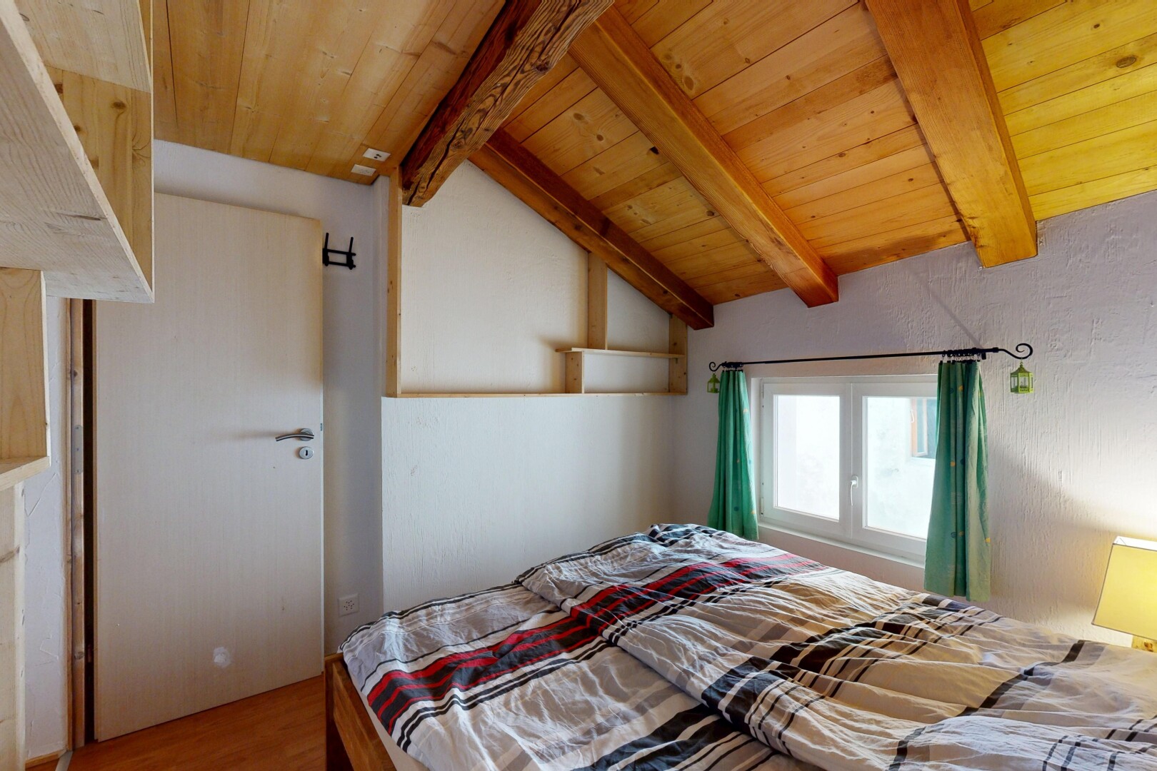 room / bedroom featuring lofted ceiling with beams, wooden ceiling, and wood finished floors