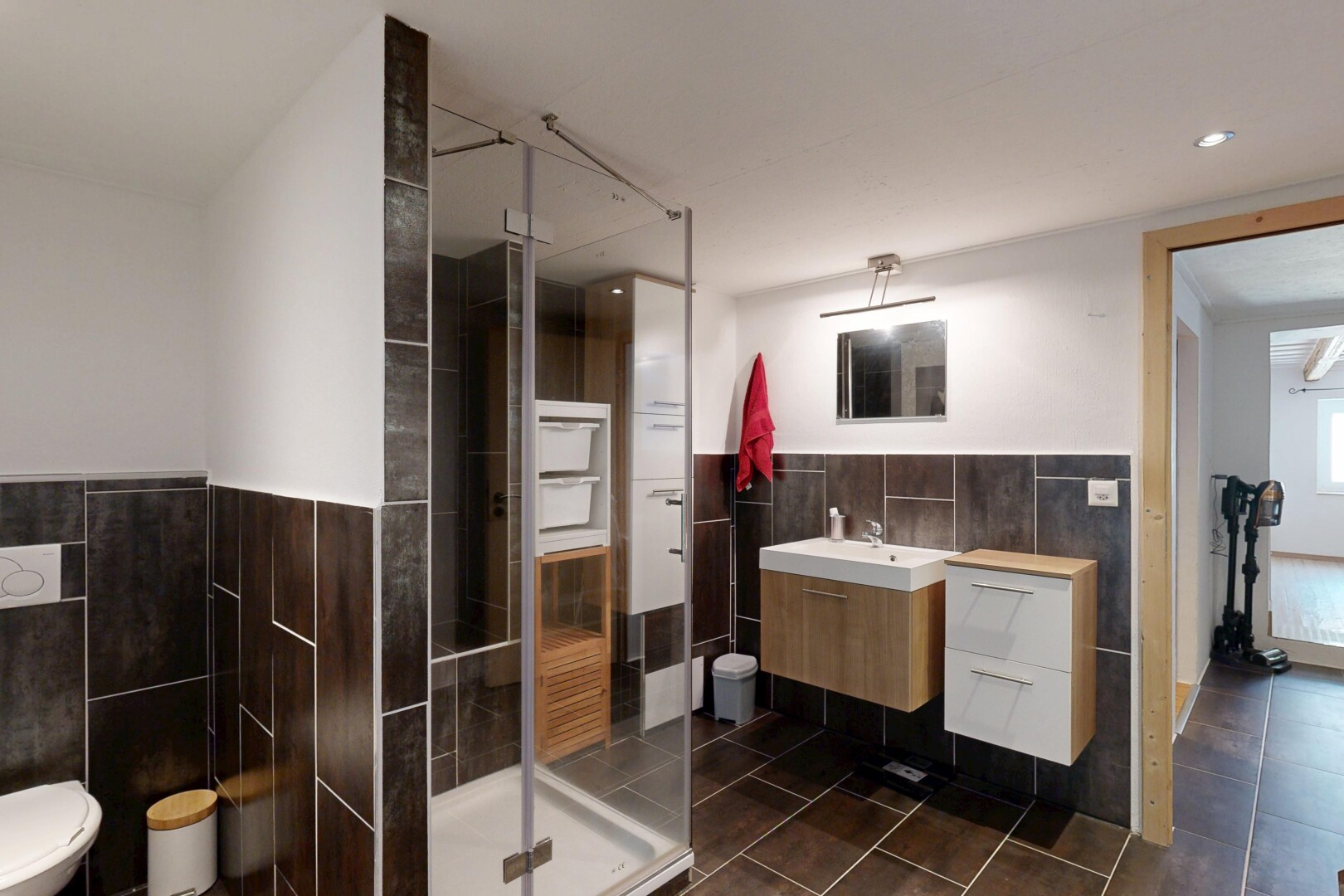 bathroom with a stall shower, tile walls, vanity, recessed lighting, and dark tile patterned flooring