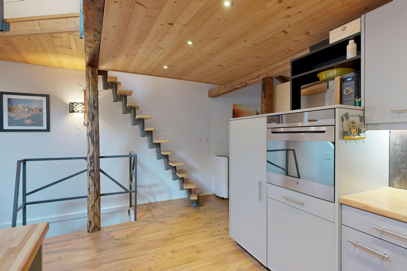 staircase featuring wood ceiling, wood finished floors, and recessed lighting