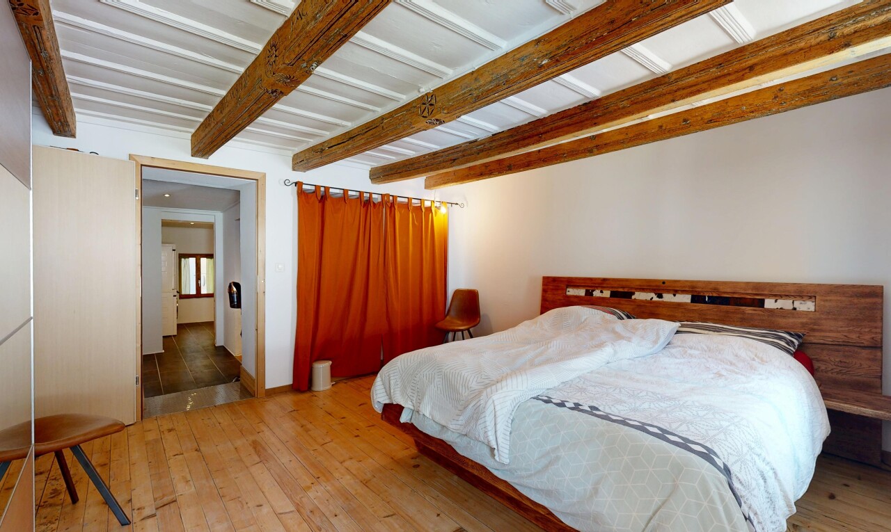room featuring beamed ceiling and light wood-type flooring