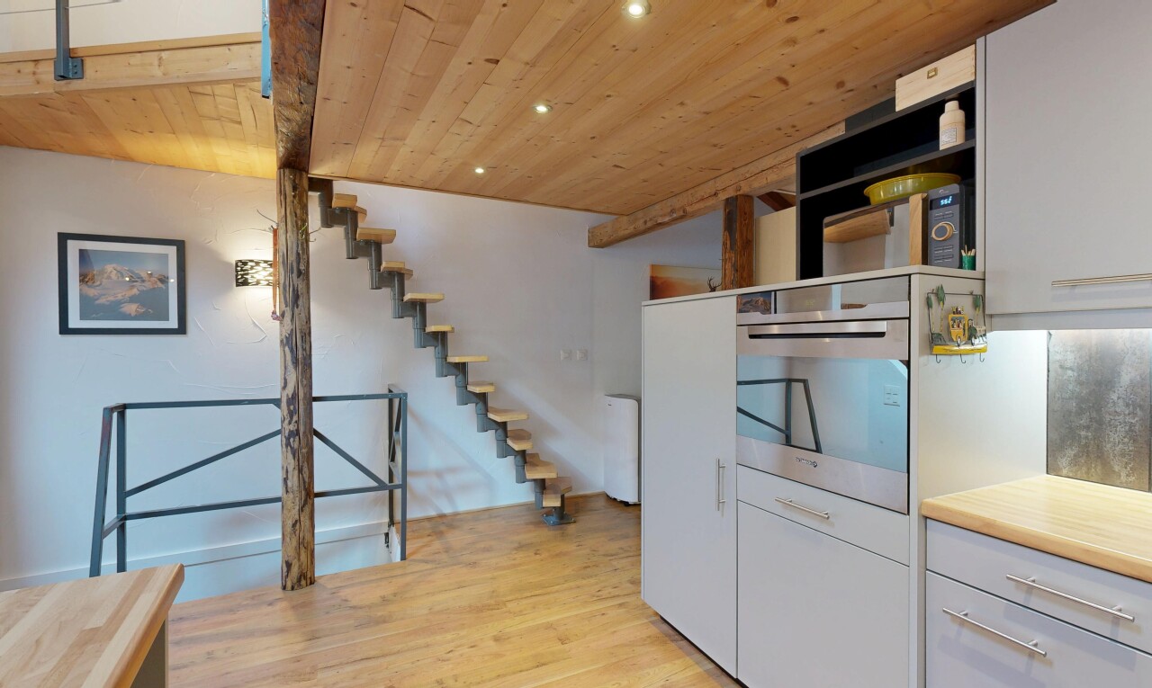staircase featuring wood ceiling, wood finished floors, and recessed lighting