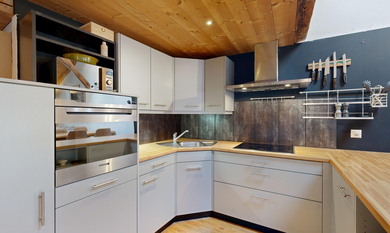 kitchen with stainless steel oven, wooden ceiling, white cabinets, open shelves, and backsplash