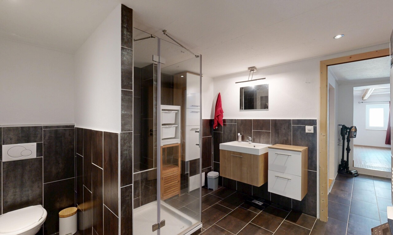 bathroom with a stall shower, tile walls, vanity, recessed lighting, and dark tile patterned flooring