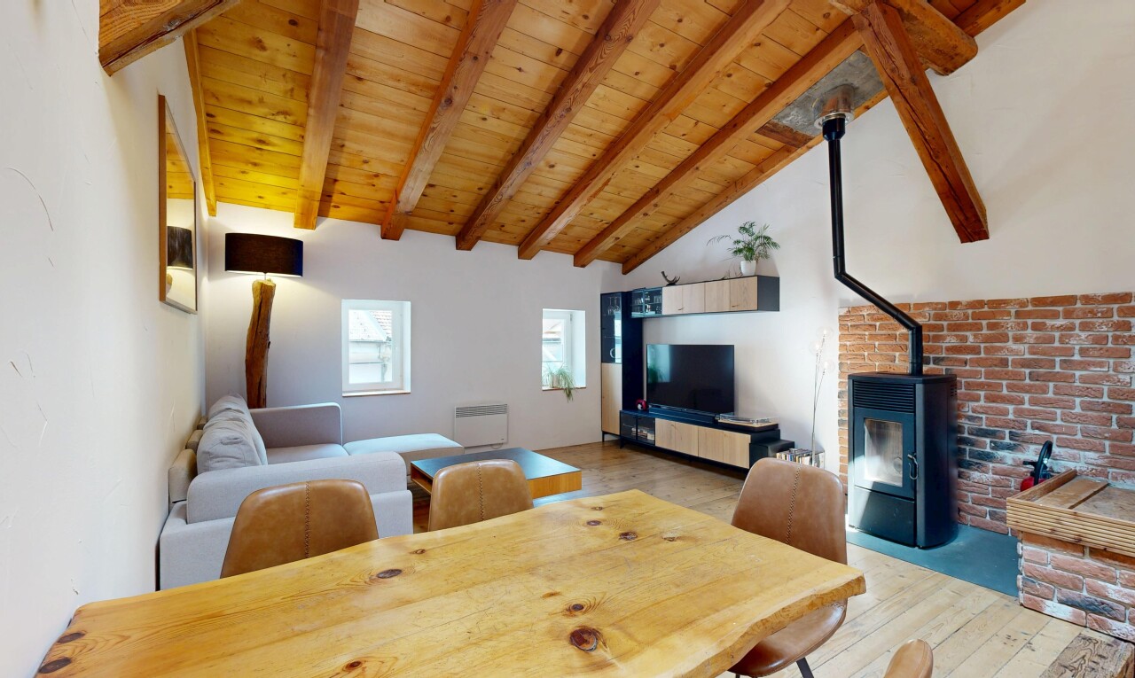 living room with a high wooden beamed ceiling and light wood-type flooring