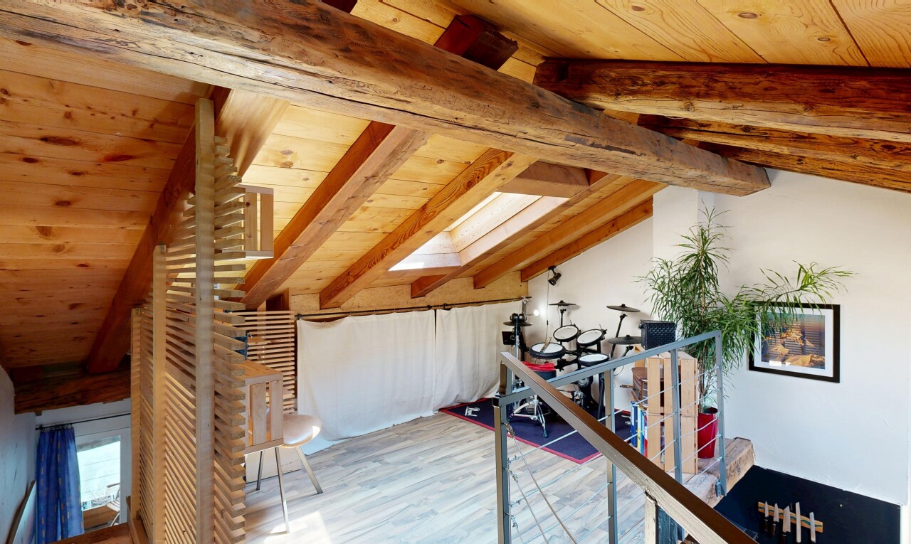 stairs featuring wood finished floors and a wood ceiling with exposed beams