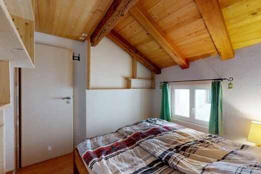 room / bedroom featuring lofted ceiling with beams, wooden ceiling, and wood finished floors