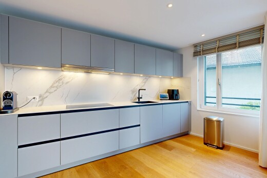 küche mit arbeitsplatten, light countertops, light floor, schränke mit flachen paneelen, und flat panel cabinets