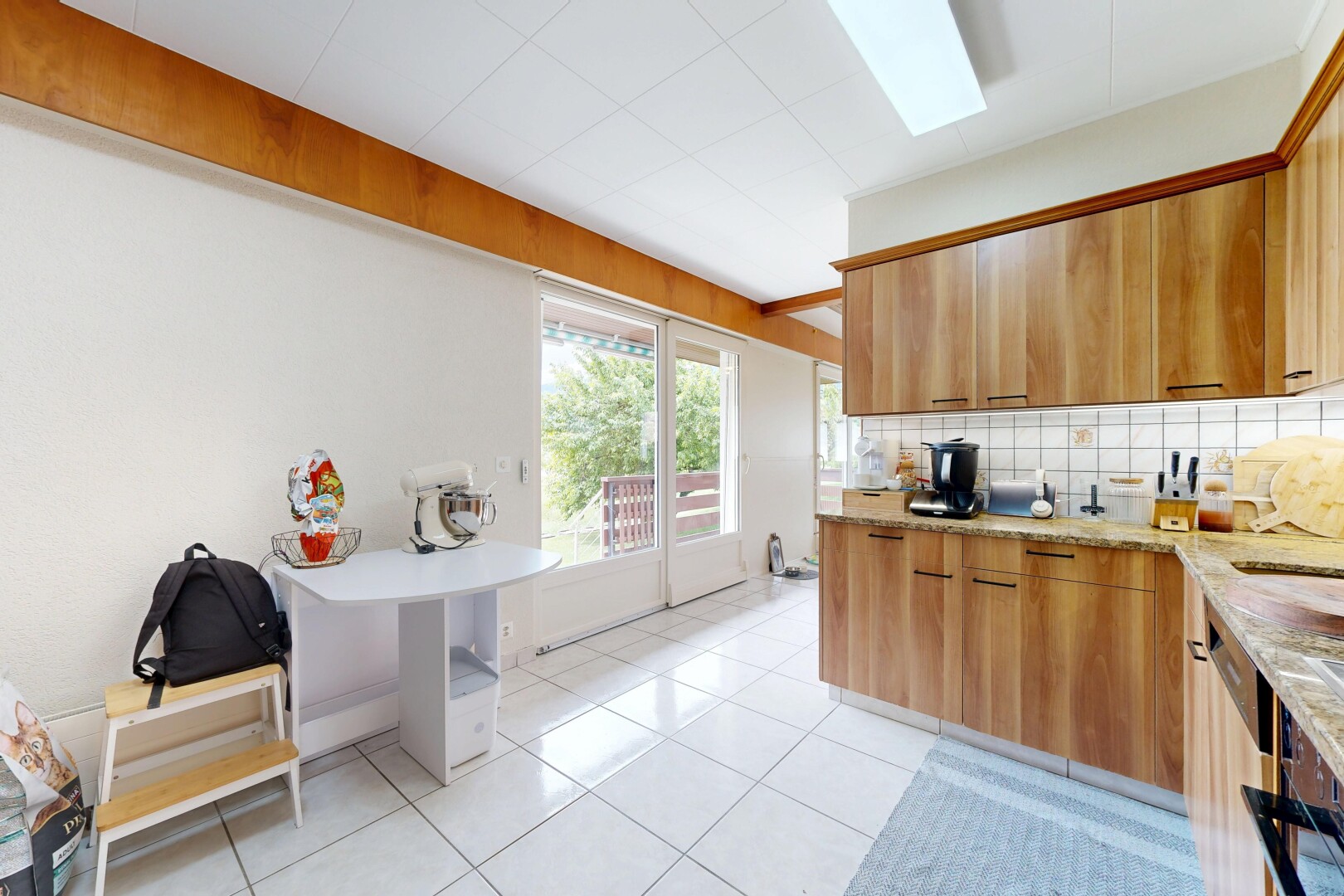 cuisine avec light countertops, light floor, dosseret, backsplash, et inside property