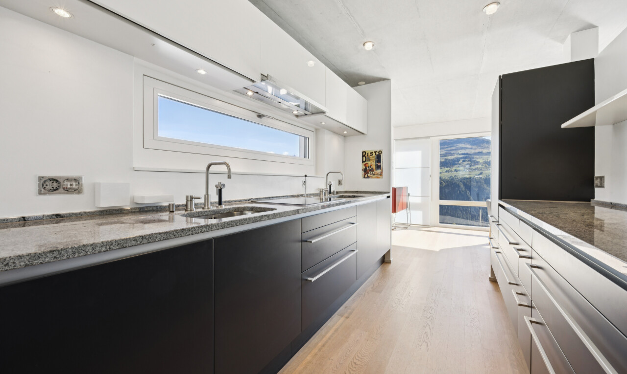two tone kitchen featuring two tone cabinetry, modern cabinets, recessed lighting, light wood-style floors, and dark stone counters