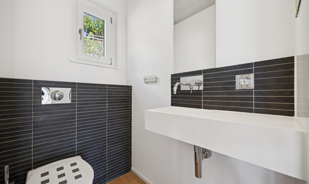 bathroom featuring tile walls and wood finished floors