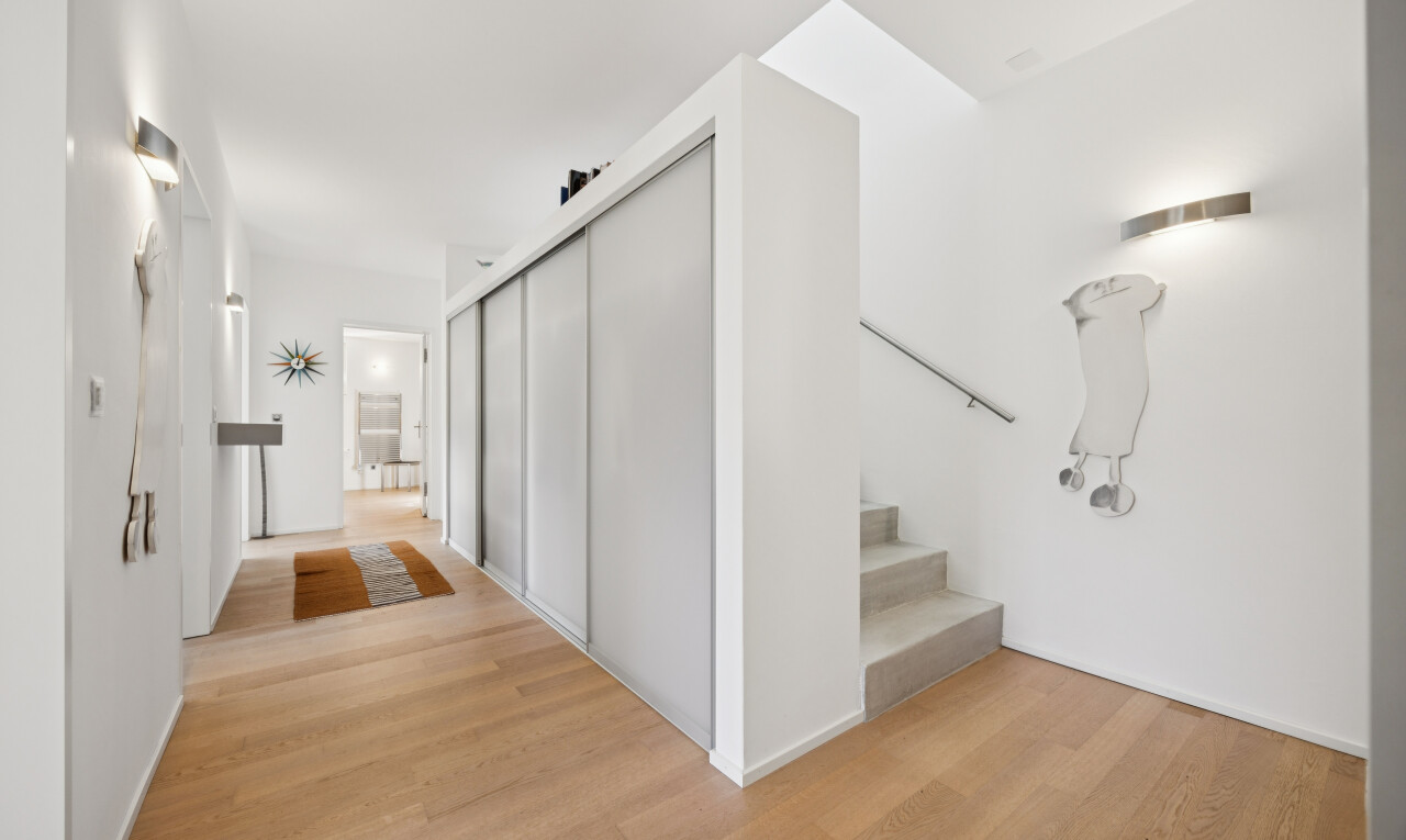 corridor featuring a closet and light wood-style flooring
